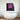 Neon cube art with statue bust above modern bathtub in luxury bathroom