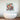 Abstract geometric bird artwork above modern freestanding bathtub in luxury bathroom