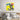 Vibrant 'We Want You' pop art wall art above modern bed, bold yellow and blue graphic decor