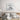Modern bedroom with abstract wall art above wooden bed, featuring neutral tones and minimalist decor