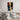 Abstract face wall art above modern bed in minimalist bedroom decor