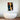 Abstract face art above modern freestanding bathtub in luxury bathroom