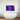LED backlit glass art with neon purple and blue lights above modern bathtub in luxury bathroom