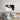 Abstract black, white, and red glass wall art above modern bed in luxury bedroom
