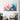 Abstract pastel swirl wall art in modern living room with checkered armchair