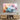 Abstract pastel cloud art print on textured wall above wooden media console