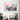Abstract pastel cloud art print on white wall above modern armchair in stylish living room
