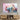 Abstract pastel cloud art print on textured wall above wooden media console