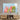 Vibrant cactus art print on glass wall panel above wooden media console in modern living room