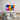 Vibrant abstract glass wall art above bed, featuring colorful paint splash design for modern bedroom decor