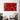 Vibrant red abstract wall art above modern houndstooth armchair in stylish living room
