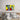 Pop art zombie giving thumbs up on wall above bed, bold yellow background, modern bedroom decor