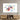 Abstract art print with colorful figures on white canvas, displayed above wooden media console in modern living room