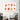 Abstract terracotta art print with organic shapes, displayed above modern armchair in minimalist living room