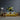 Vibrant abstract art glass panel above yellow sofa in modern living room