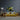 Vibrant abstract art glass panel above yellow sofa in modern living room