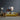 Abstract floral wall art above yellow sofa in modern living room with wooden side tables