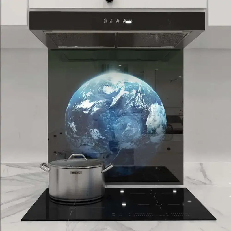 Bespoke glass kitchen splashback with Earth image, modern induction hob, and stainless steel pot