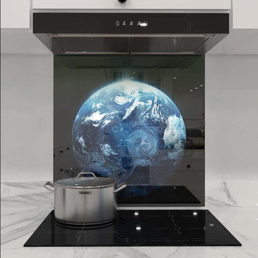 Bespoke glass kitchen splashback with Earth image, modern induction hob, and stainless steel pot
