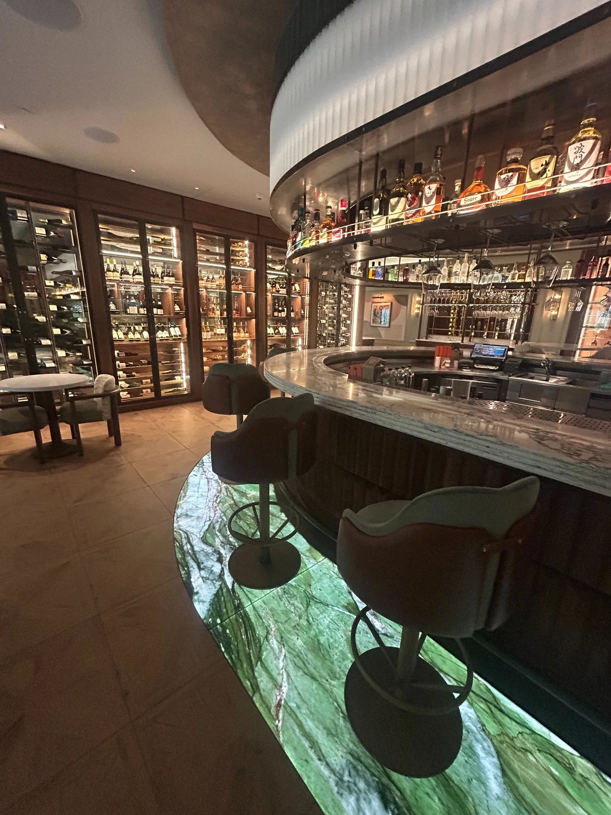 Luxury hotel bar with bespoke illuminated glass flooring at Fairmont Windsor Park