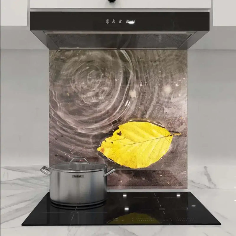 Bespoke kitchen splashback with artistic yellow leaf design, modern glass panel for luxury interiors