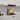 Decorative glass splashback with yellow leaf design in modern white kitchen, featuring marble countertop and induction hob