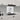 Abstract face art glass splashback in modern white kitchen with marble countertop