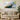 Abstract galaxy wall art with blue, yellow, and white swirls above beige sofa in modern living room