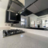 Modern kitchen with sleek glass backsplash and stainless steel range hood