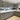 Modern kitchen with sleek grey cabinets, white countertops, and under-cabinet lighting
