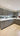 Modern kitchen with sleek grey cabinets, white countertops, and under-cabinet lighting