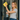 Woman cleaning a glass door with a yellow cloth and spray bottle.