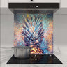 Vibrant pineapple art glass splashback in modern kitchen with induction hob