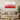 Modern living room with beige sofa, wooden coffee table, greenery, and red to white gradient wall art