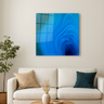 Abstract blue ice cave wall art print with swirling patterns hanging above beige sofa