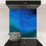 Modern kitchen stove with stainless steel pot and blue agate stone backsplash under stainless steel hood