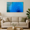 Modern beige living room with blue abstract ice cave wall art, sofa, wooden coffee table, and green plant