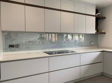 Modern kitchen with frosted glass backsplash and sleek white cabinetry