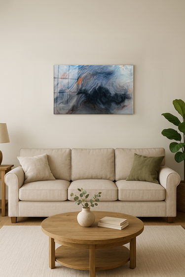 Modern beige sofa with green and beige pillows in living room featuring abstract wall art and round wooden coffee table