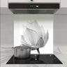 Bespoke floral glass splashback in modern kitchen with induction hob and extractor hood