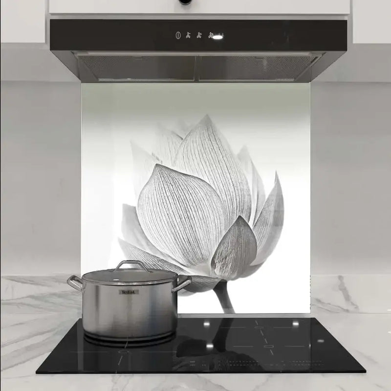 Bespoke floral glass splashback in modern kitchen with induction hob and extractor hood
