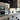 Black marble-veined glass backsplash in modern kitchen with stainless steel appliances