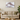 Modern living room with beige sofa, wooden coffee table, marble wall art with rose gold veins, and indoor plant