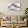 Modern living room with beige sofa, wooden coffee table, marble wall art with rose gold veins, and indoor plant