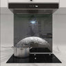 Custom moon-themed glass splashback in modern kitchen with induction hob and extractor hood
