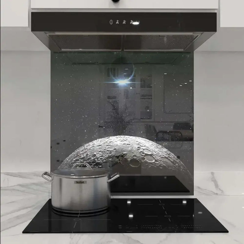 Custom moon-themed glass splashback in modern kitchen with induction hob and extractor hood