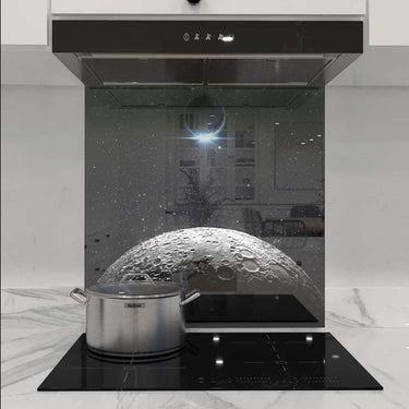 Custom moon-themed glass splashback in modern kitchen with induction hob and extractor hood