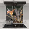 Bespoke floral glass splashback in modern kitchen with induction hob and extractor hood