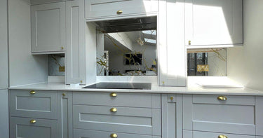 Bespoke decorative glass mirror with etched branch design in modern kitchen, featuring luxury residential glass solutions.