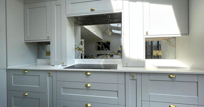 Bespoke decorative glass mirror with etched branch design in modern kitchen, featuring luxury residential glass solutions.